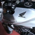 Honda motorcycle with a silver tank on which the Japanese motorcycle manufacturer has placed its sign with black wings