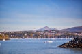 HONDARRIBIA, SPAIN - OCTOBER 27, 2021: Plane descending over the harbor with fishing boats in Hondarribia, Basque Country, Spain