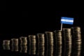 Honduran flag with lot of coins on black