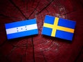 Honduras flag with Swedish flag on a tree stump Royalty Free Stock Photo