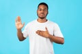 Honest African American Man Doing Swear Gesture Over Blue Background Royalty Free Stock Photo