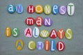 An honest man is always a child, creative quote composed with multi colored stone letters over green sand