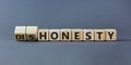 Honesty or dishonesty symbol. Turned cube and changed the word `dishonesty` to `honesty`. Beautiful grey background. Business