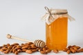 Honey with almonds and hohey spoon