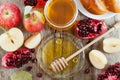 Honey, apple, pomegranate and bread hala, table set with traditional food for Jewish New Year Holiday, Rosh Hashana Royalty Free Stock Photo