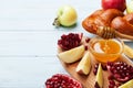 Honey, apple slices, pomegranate and hala. Table set with traditional food for Jewish New Year Holiday, Rosh Hashana.