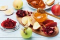 Honey,apple slices,pomegranate and hala on wooden board. Table set with traditional food for Jewish New Year Holiday,Rosh Hashana. Royalty Free Stock Photo