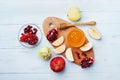 Honey, apple slices and pomegranate serve on kitchen board top view. Table set with traditional food for Jewish New Year Holiday,