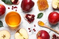 Honey, apples and pomegranate on white table, flat lay. Rosh Hashanah holiday Royalty Free Stock Photo