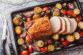 Honey baked pork loin with potatoes, onions, bell peppers and mushrooms close-up on a baking sheet. Horizontal top view Royalty Free Stock Photo