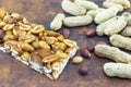 Honey bar with peanuts almonds and hazelnuts surrounded by roast Royalty Free Stock Photo