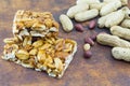 Honey bar with peanuts almonds and hazelnuts surrounded by roast Royalty Free Stock Photo