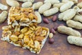 Honey bar with peanuts almonds and hazelnuts surrounded by roast Royalty Free Stock Photo