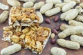 Honey bar with peanuts almonds and hazelnuts surrounded by roast Royalty Free Stock Photo