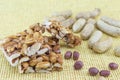 Honey bar with peanuts almonds and hazelnuts surrounded by roast Royalty Free Stock Photo