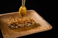 Honey being poured into granola bar Royalty Free Stock Photo