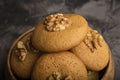 Honey biscuits with walnuts in a wooden bowl.