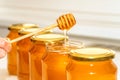 Honey in bottles. Honey dipper Royalty Free Stock Photo