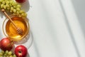 Honey Bowl with Apples and Grapes on Light Background Royalty Free Stock Photo