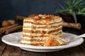 Honey cake with almonds on white plate