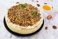 Honey cake with cottage cheese, oranges and nuts, decorated with white chocolate Royalty Free Stock Photo