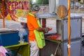 Honey chicken shop on the night market at Putrajaya, Kuala Lumpur. Man grills the marinated chicken on a small grill. The meat has