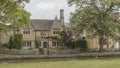 Honey coloured Cotswolds cottages on the river Windrush