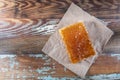 Honey Comb and Brown Paper on Old Table Top Royalty Free Stock Photo