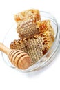 Honey comb in a glass bowl and wooden stick. Royalty Free Stock Photo