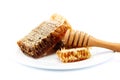 Honey comb in a platel and wooden stick. Royalty Free Stock Photo