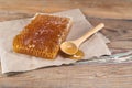 Honey Comb and Spilled Honey on Wooden Board Royalty Free Stock Photo