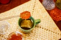 Honey dipper closeup dripping over steeping tea in mug