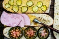 Sandwich making baguette halves spread with mustard and pickles