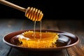 honey dripper over a bowl filled with raw honey