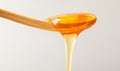 Honey dripping. Close up, honey dipping from the wooden honey spoon. Royalty Free Stock Photo