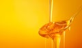 Honey dripping. Close up, honey dipping from the wooden honey spoon. Royalty Free Stock Photo