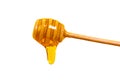 Honey dripping from honey dipper isolated on white background. Royalty Free Stock Photo