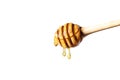 Honey dripping from honey dipper on white background. Royalty Free Stock Photo