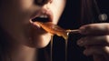 Thick honey dripping from the wooden honey spoon.Beauty model woman open mouth. Healthy food concept, diet, dessert, generative ai Royalty Free Stock Photo