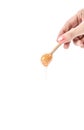 Honey dripping, honey dipper with hand on white background Royalty Free Stock Photo