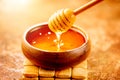 Honey dripping from honey dipper in wooden bowl.  Close-up. Healthy organic Thick honey dipping from the wooden honey spoon Royalty Free Stock Photo