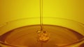 Honey dripping, pouring from spoon in glass. Thick honey molasses dripping into full glass. Close up of golden honey Royalty Free Stock Photo
