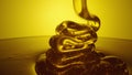 Honey dripping, pouring thick stream on yellow background. Viscous honey molasses flowing. Close up of golden honey