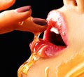 Honey dripping on girl lips. Beauty model woman eating honey Royalty Free Stock Photo