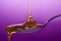 Honey dripping on spoon Royalty Free Stock Photo