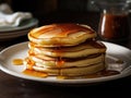 Honey dripping on the stack of pancakes for breakfast on the wooden table, healthy products by organic natural ingredients concept