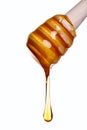 Honey dripping from a wooden dipper