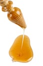 Honey dripping from a wooden honey dipper