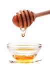 Honey dripping from a wooden honey dipper isolated on white back Royalty Free Stock Photo