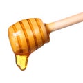 Honey dripping from wooden honey dipper isolated on white Royalty Free Stock Photo